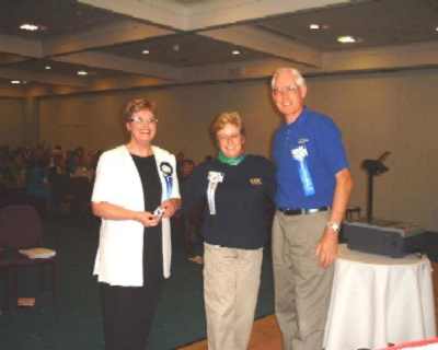 Barabara Kelly presents Distinguished President and Secretary award to Patsy Hill and Tony Popplewell